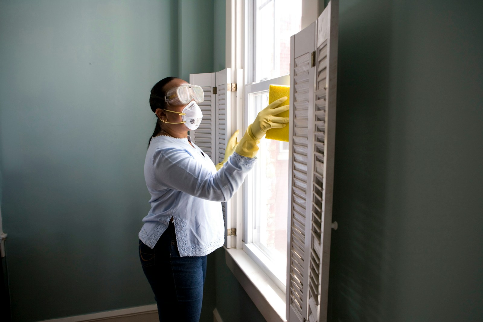 Professional cleaner wiping a bright kitchen counter